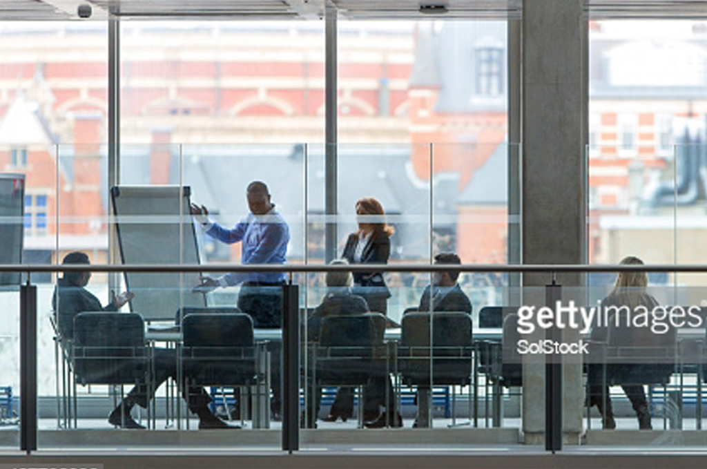 A lot of people having a meeting in a corporate meeting room
