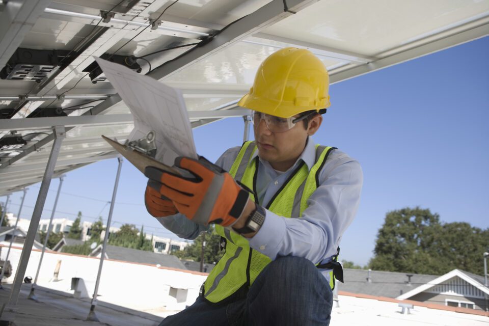maintenance worker monitoring solar panels